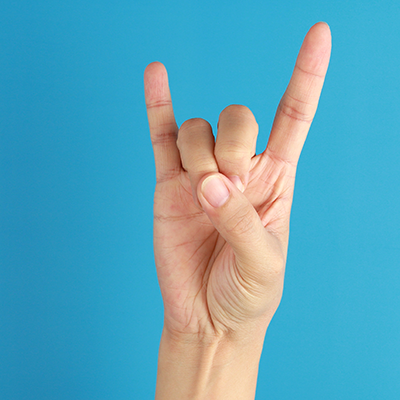 Is the "horns" hand gesture offensive in some cultures?