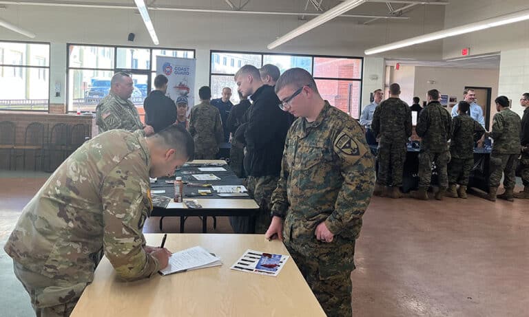 Cadets visit with military recruiters at an on-campus event to learn more about military service.