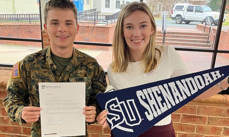 A representative from Shenandoah University offers direct admission to a cadet during a visit to the Fork Union campus.