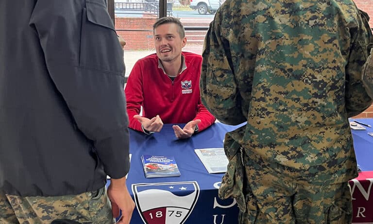 A representative from Shenandoah University visits with cadets on the Fork Union campus.