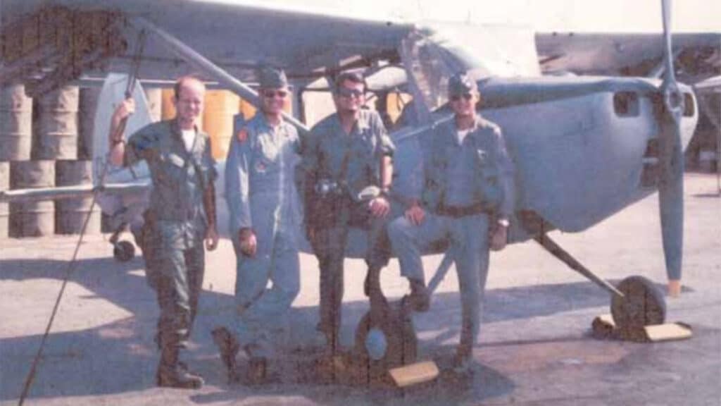 John Jackson (second from left) standing with members of his crew and a fellow FAC pilot in front of the light Cessna O-1 "Bird Dog" 
airplane he piloted in Vietnam in 398 combat missions as a Forward Air Controller.